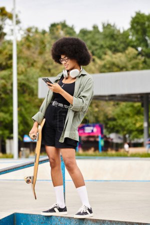 A young African American woman with curly hair confidently stands on a ledge with her skateboard in a skate park setting.