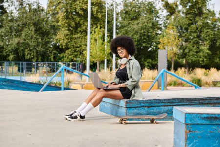 A woman with curly hair sits on a bench, tapping on a laptop outdoors in a vibrant urban setting.