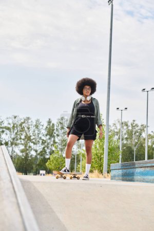 A young African American woman with curly hair confidently skateboards down a city sidewalk on a sunny day.