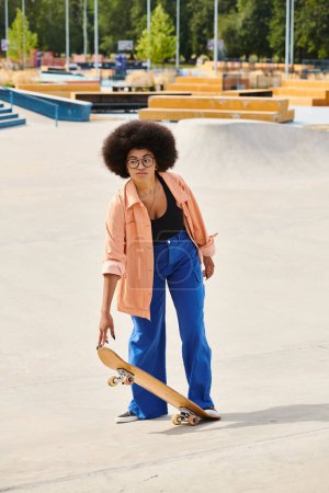 Young African American woman confidently stands on a skateboard in a bustling skate park, showcasing her skills and style.