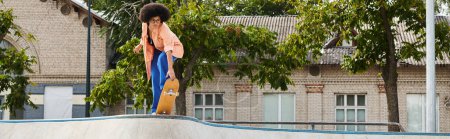 Photo for A young man energetically rides a skateboard up a ramp in a skate park, showcasing his skills and determination. - Royalty Free Image
