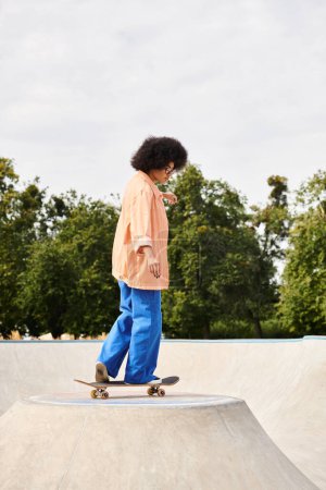 Young African American woman with curly hair showing off her skateboarding skills on a ramp at a skate park.