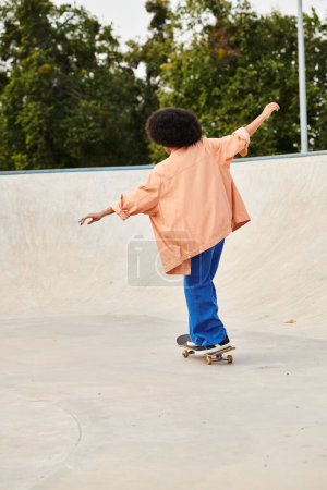 Photo for A young African American boy with curly hair confidently rides his skateboard at a bustling skate park. - Royalty Free Image