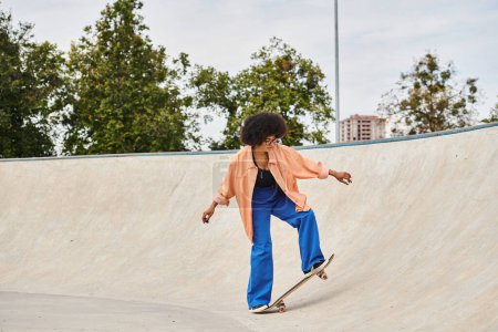 Photo for A young African American woman with curly hair boldly rides her skateboard up the side of a ramp at the skate park. - Royalty Free Image