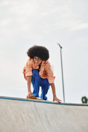 Photo for A young African American girl confidently stands on a skateboard, honing her skills in a skate park. - Royalty Free Image