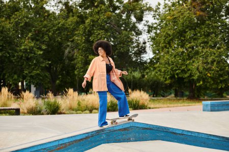 A young African American woman with curly hair rides a skateboard on a ramp at a skate park, performing daring tricks.