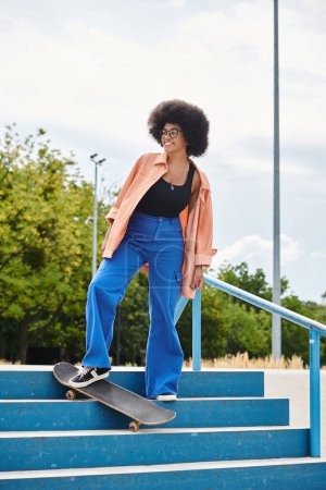 An African American woman with curly hair skillfully skateboarding down a staircase in an urban skate park.