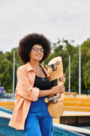 A young African American woman with a voluminous afro hairdo confidently holding a skateboard at a vibrant skate park.