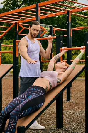 A determined woman in sportswear working out together on a bench with a personal trainer.