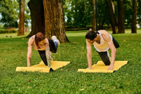 A man and woman in sportswear engage in partner yoga poses with determination and motivation during an outdoor session.