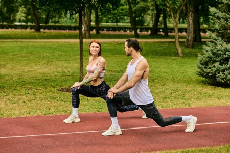 A dedicated woman in sportswear practice sport with determination guided by their personal trainer in a peaceful park setting.