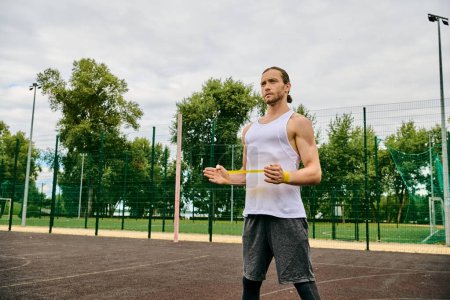 A determined man in sportswear having resistance band training
