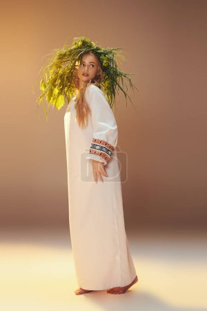 A young mavka in a traditional white dress delicately balances a plant on her head in a fairy-like and fantastical studio setting.