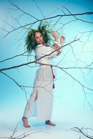 A young woman in a white dress gracefully holds a delicate branch, embodying serenity and connection to the natural world.
