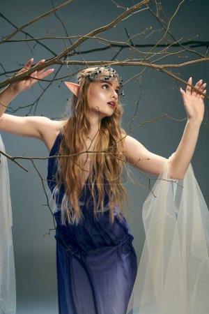 Une jeune femme en robe bleue tenant gracieusement une branche d'arbre, incarnant l'essence d'une princesse fée dans un cadre mystique.