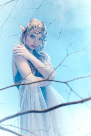 A young woman adorned in a white dress and tiara exudes elegance and grace as she embodies the essence of a fairy tale princess.