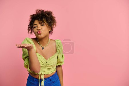 Young African American woman in stylish attire making a funny face with her hands.