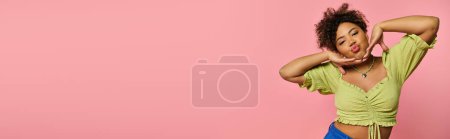 Photo for Stylish African American woman striking pose against colorful backdrop. - Royalty Free Image