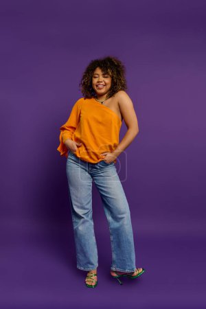 Stylish African American woman posing in orange top against vibrant backdrop.