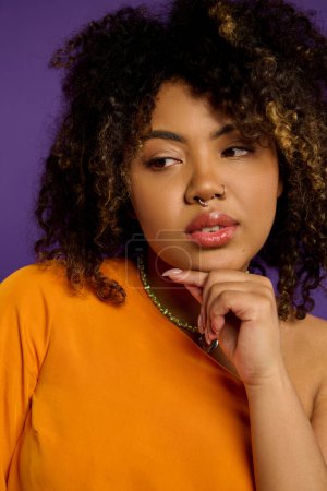 A beautiful African American woman with curly hair, dressed stylishly, posing against a vibrant backdrop.