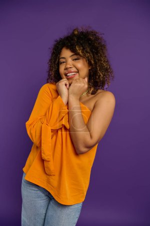 Photo for Stylish African American woman strikes pose with hand on chin, showcasing emotions. - Royalty Free Image