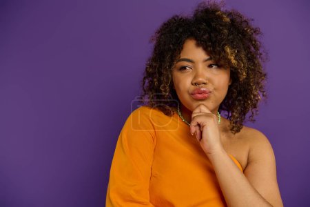 Photo for Stylish African American woman with curly hair poses against vibrant backdrop. - Royalty Free Image
