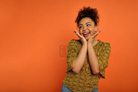 Photo for African American woman in stylish attire, hands on face, expressing deep emotion. - Royalty Free Image
