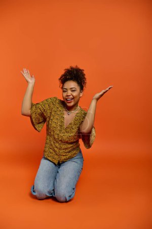 Photo for Stylish African American woman with arms raised in vibrant backdrop. - Royalty Free Image