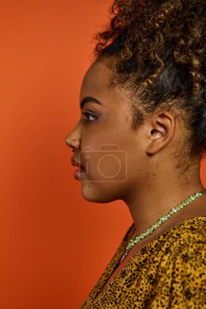 Photo for A beautiful African American woman in stylish attire, showcasing a necklace. - Royalty Free Image
