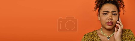 Photo for An African American woman in stylish attire looks surprised. - Royalty Free Image