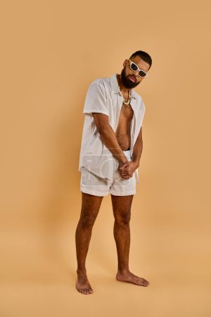 A bearded man with a white shirt and shorts walks confidently, exuding a sense of casual elegance and free-spirited charm.