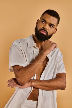 A man with a full beard and wearing a white shirt exudes a sense of wisdom and calmness. His serene expression captivates the viewer, inviting introspection and contemplation.