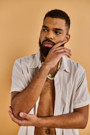 Photo for A bearded man with no shirt strikes a confident pose, exuding masculinity and strength as he gazes into the distance. - Royalty Free Image
