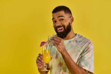 A man, with a serene expression, holds a glass of vivid orange juice, the condensation glistening on the glass.