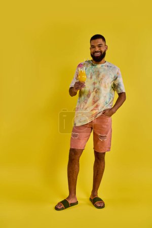 Photo for A solitary man stands in front of a vibrant yellow background, his silhouette stark against the bright color. - Royalty Free Image