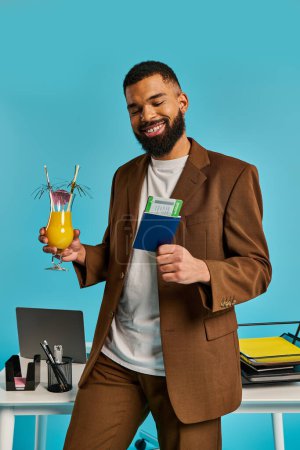 Photo for A sophisticated man in a stylish suit holding a drink and a book in a refined setting. - Royalty Free Image