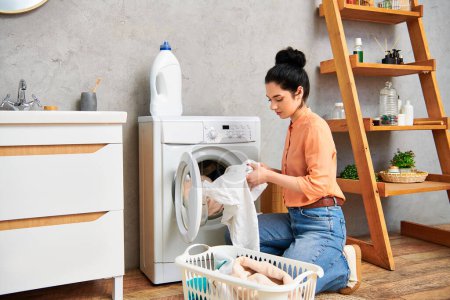 Eine stilvolle Frau in lässiger Kleidung sitzt neben einer Waschmaschine und nimmt einen Moment der Ruhe inmitten der Arbeit beim Wäschewaschen ein..