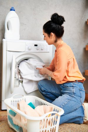 A stylish woman in casual attire sits next to a washing machine, focused on cleaning her home.