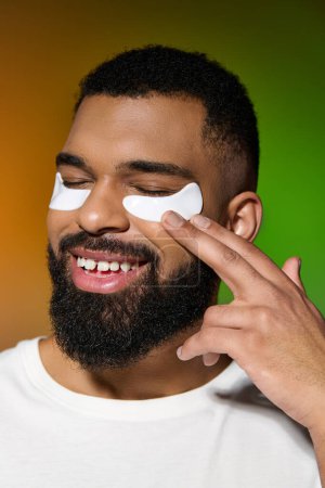 African american stylish man using eye patches.