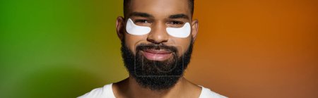 Photo for African american handsome man using eye patches. - Royalty Free Image