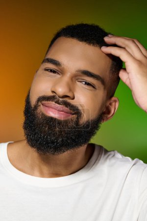 Photo for A handsome young man with a beard focused on his skincare routine. - Royalty Free Image