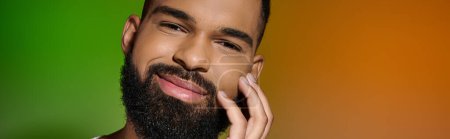 Photo for Close-up of a handsome young man executing his skincare routine, focusing on his full beard. - Royalty Free Image