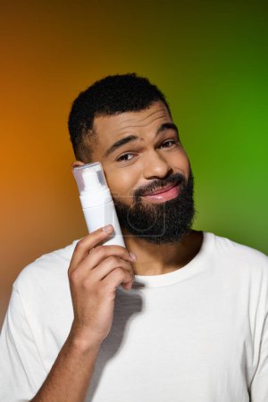 African american handsome man holds shaving cream.