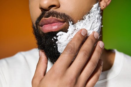 Photo for Handsome young man shaving his face up close. - Royalty Free Image