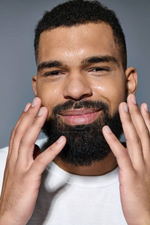 A young man with a beard engaging in a skincare routine.