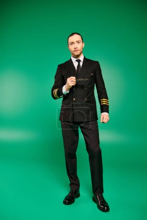 A handsome male pilot in a black uniform strikes a pose against a vibrant green backdrop.