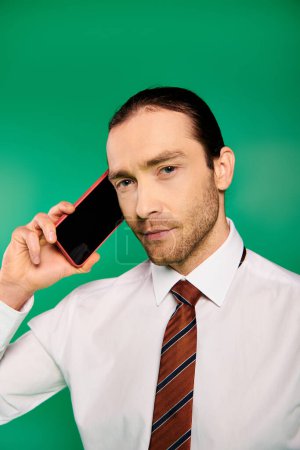 Handsome businessman in elegant attire talking on cell phone.