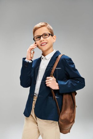 Photo for Young man in glasses speaks on cell phone. - Royalty Free Image