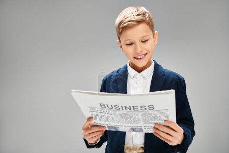Preadolescent boy in elegant suit, engrossed in reading a newspaper.