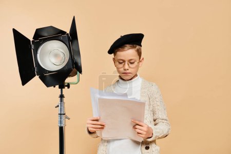 Photo for Preadolescent boy in white shirt and black hat reads a piece of paper. - Royalty Free Image
